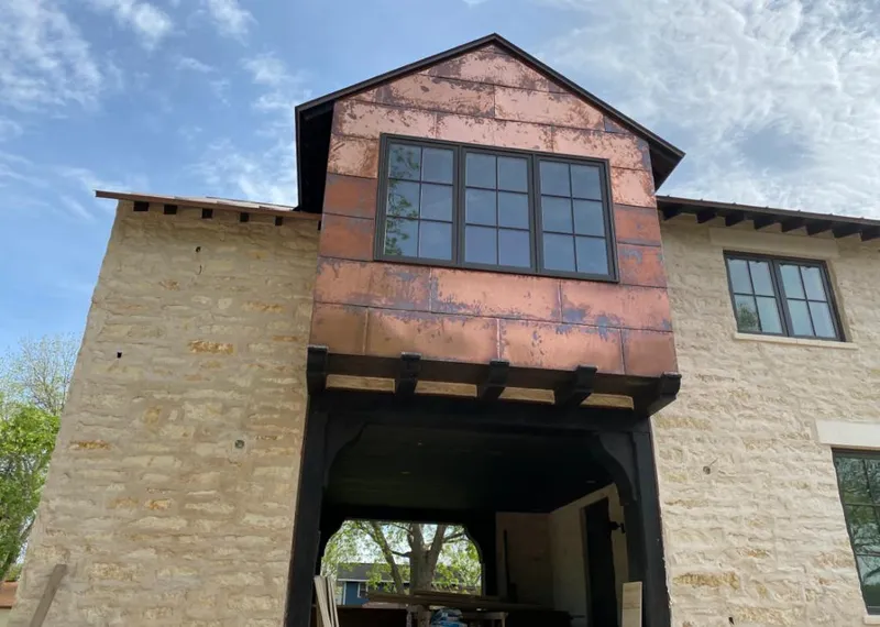 Copper metal panel facade on a stone building for Roof Repair in Gulf Breeze